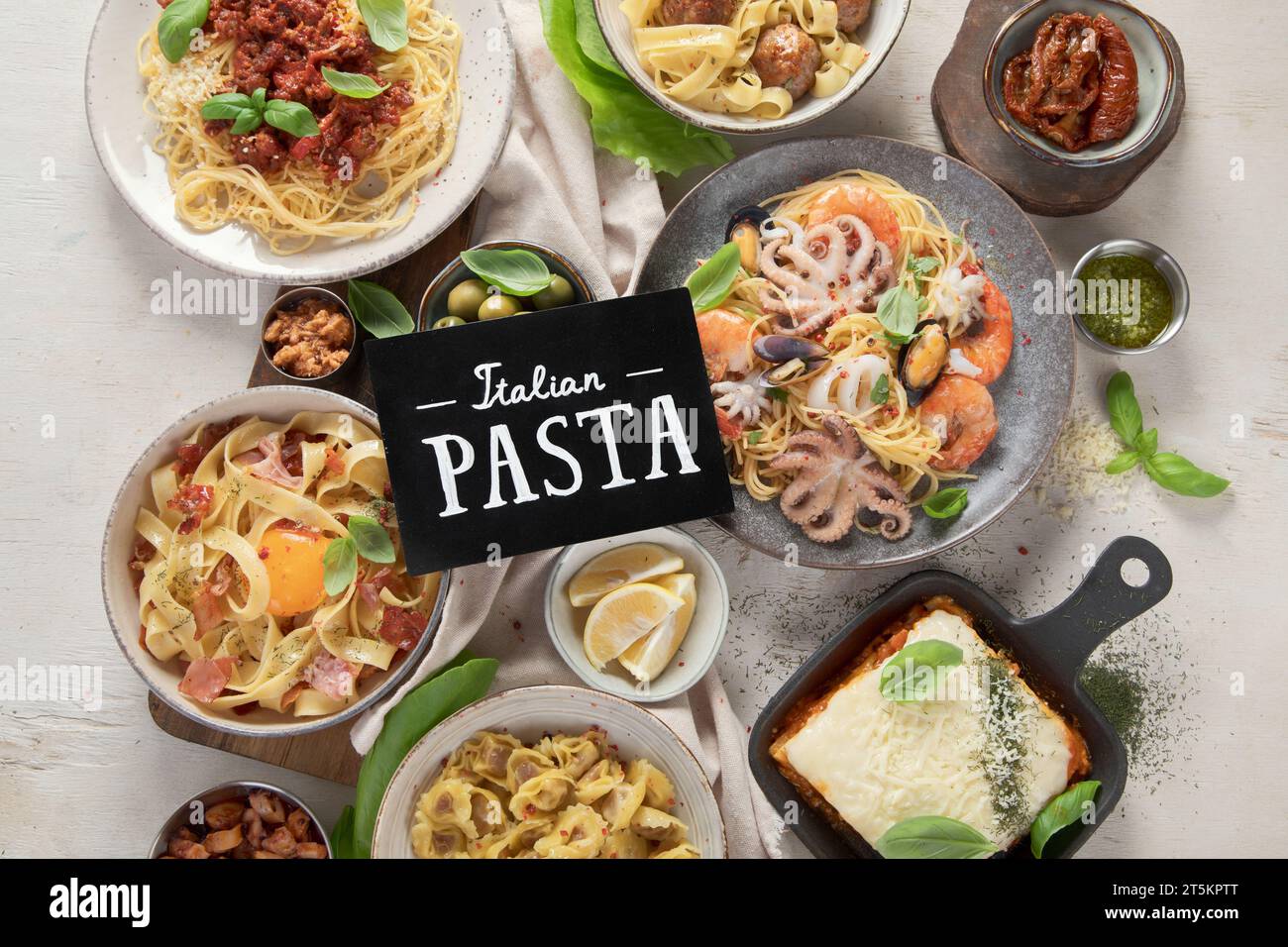 Assortment of Italian pasta dishes on light bachground. Traditional food concept. Top view Stock Photo