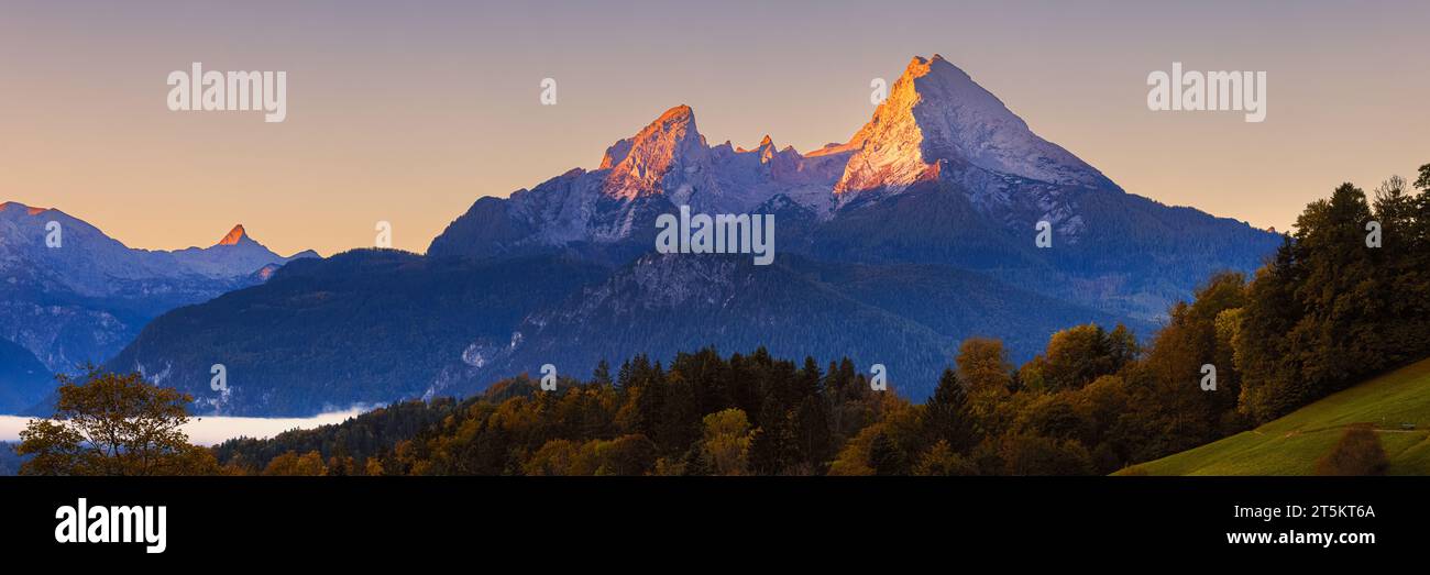 A wide 3:1 panoramic image from a sunrise in Autumn at the Watzmann mountain near Berchtesgaden in Berchtesgadener land in Bavaria, southeastern Germa Stock Photo
