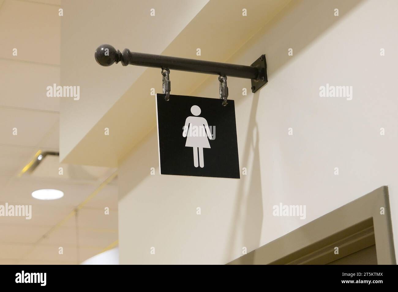 A woman washroom logo on the wall Stock Photo