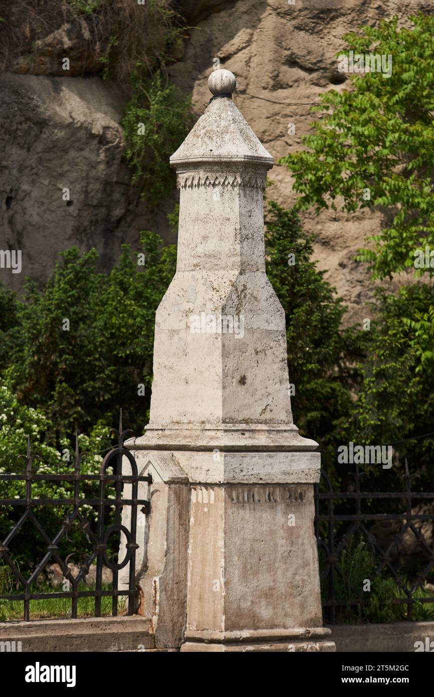 Stone sculpture on the fence of Gellert Hill Cave (Hungarian: Gellérthegyi-barlang). Budapest, Hungary - 7 May, 2019 Stock Photo