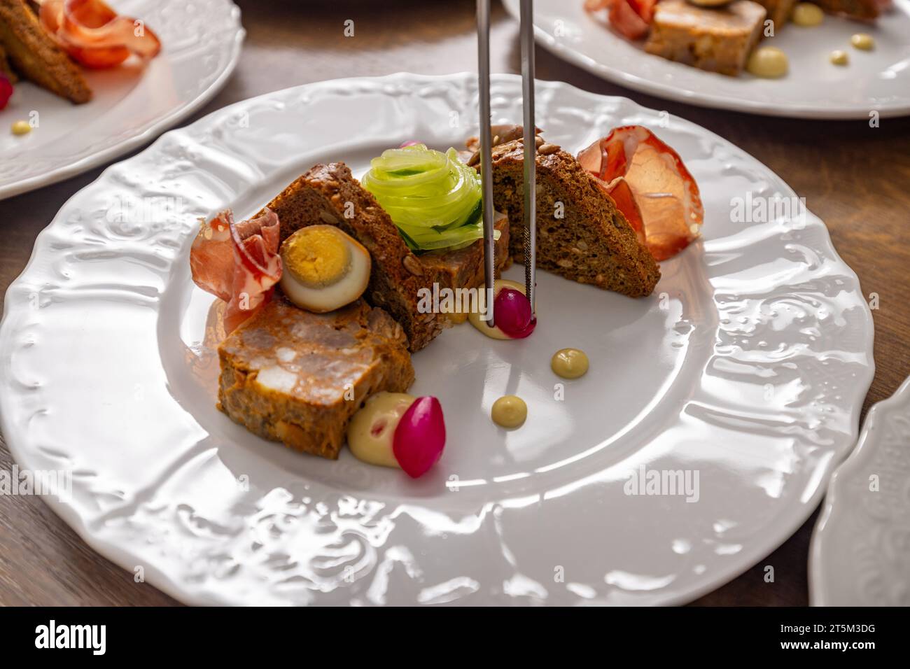 Scene encapsulates the art of culinary presentation in a professional kitchen setting. Stock Photo