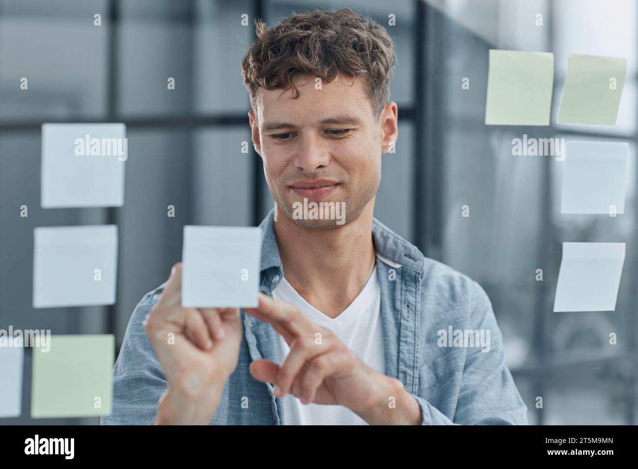 young office man at workplace making notes Stock Photo