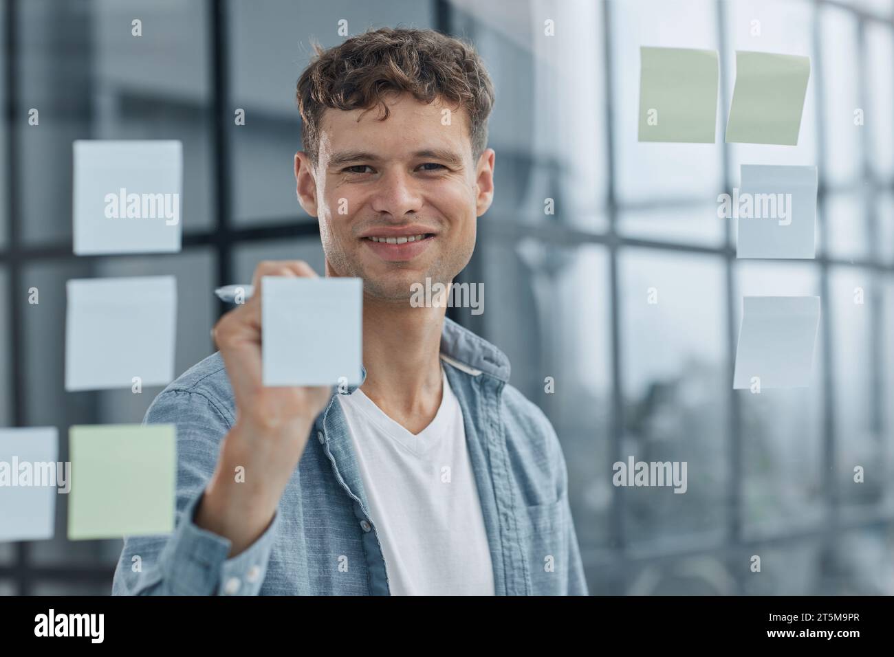 young office man at workplace making notes Stock Photo