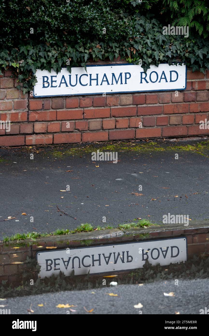 Beauchamp Road sign reflected on a puddle, Leamington Spa, Warwickshire