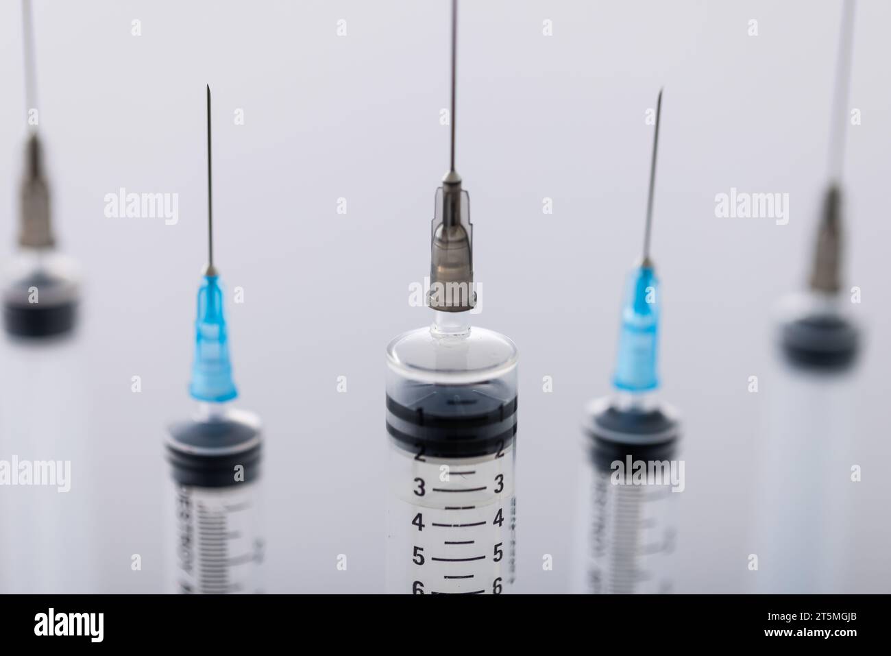 Close up of laboratory syringes with needles and copy space on white