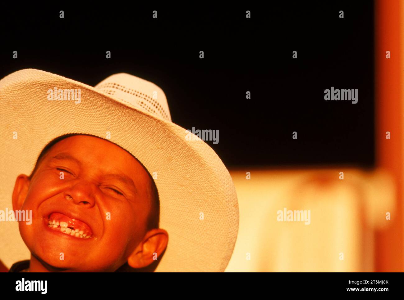 A young boy wears a cowboy hat and smiles, Arizona, USA. Stock Photo