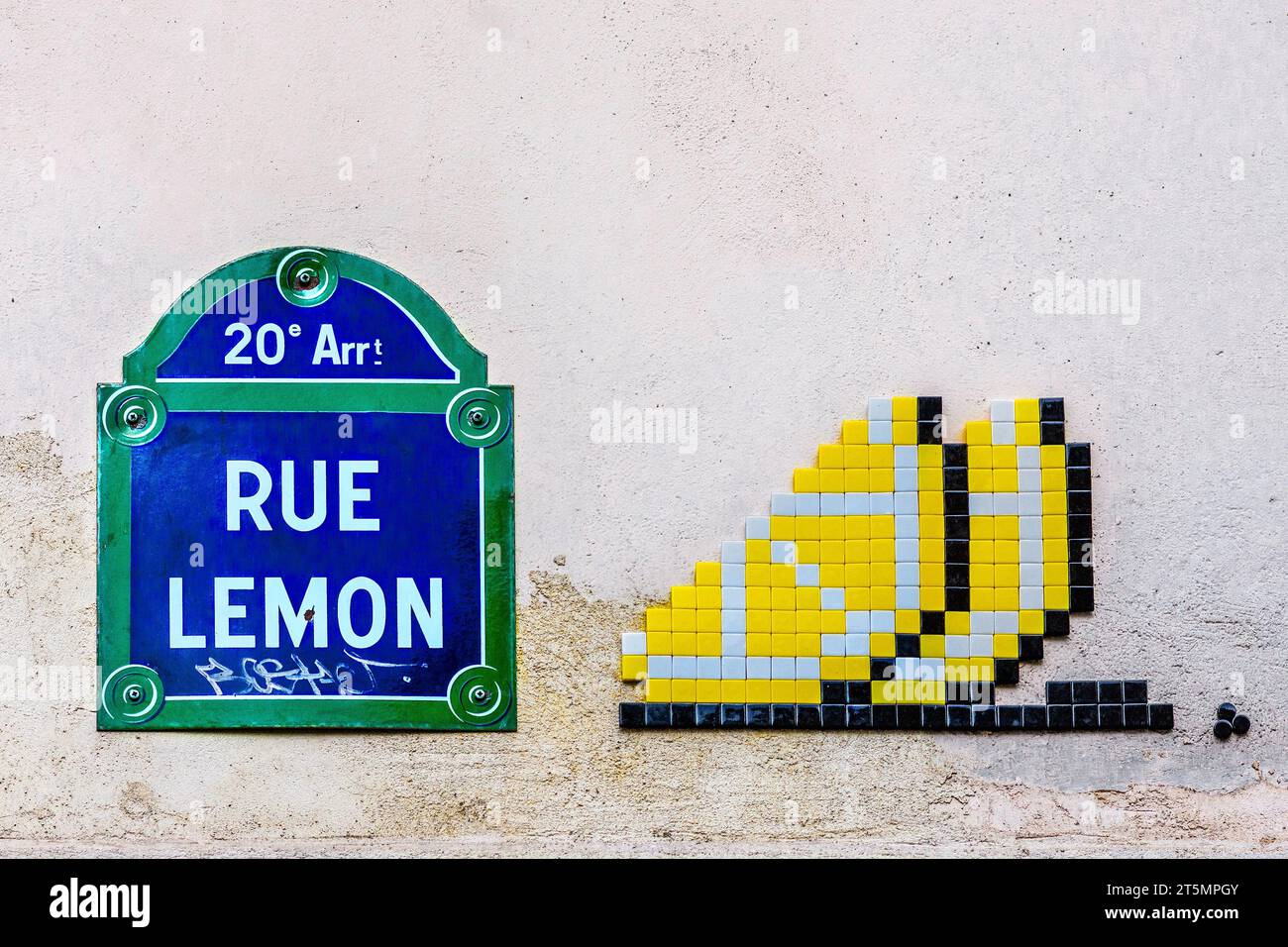 Rue Lemon street sign with tiled tag by famous French street artist 'Invader' - Belleville, Paris 20, France. Stock Photo