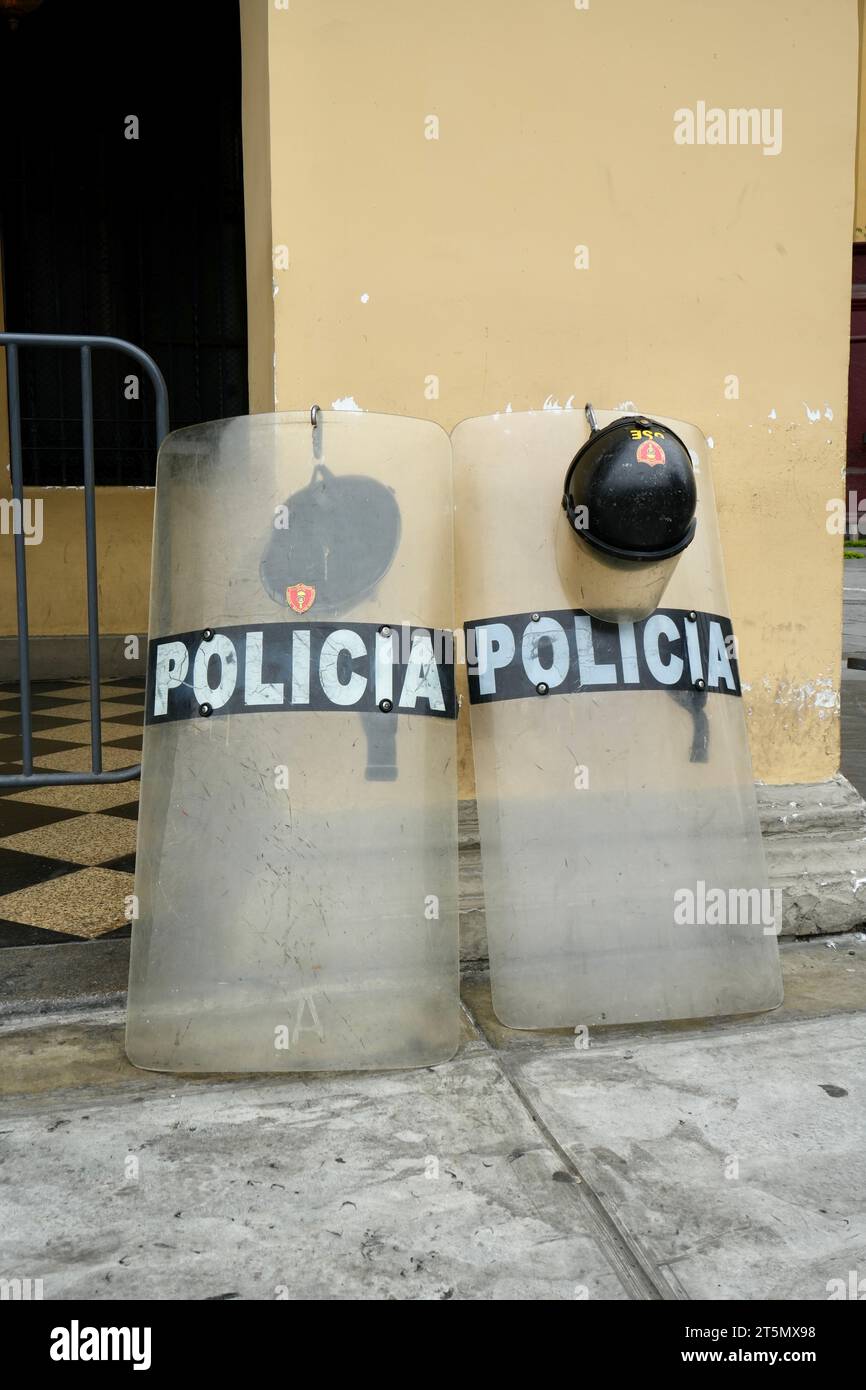 Police Riot Sheilds and helmets propped up against a wall. Lima, Peru, October 3, 2023. Stock Photo