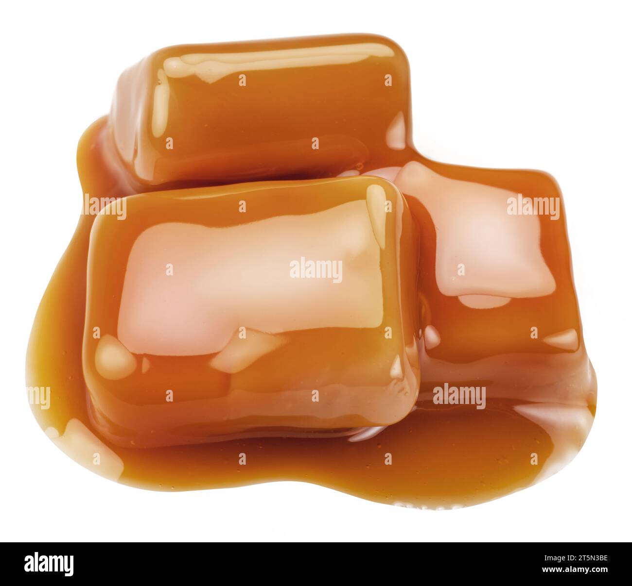 Caramel candies in milk caramel sauce isolated on white background