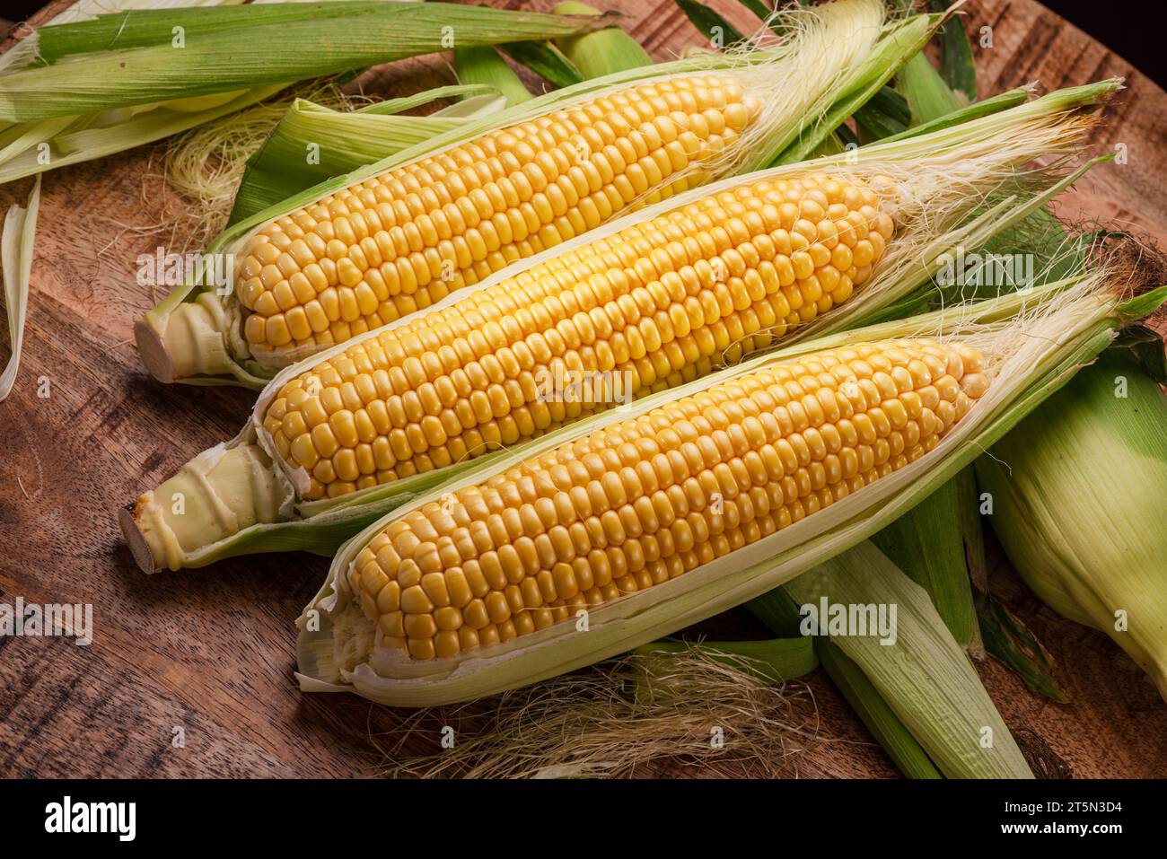 Ripe corn heads with corn whiskers and leaves. Nice vegetable cooking