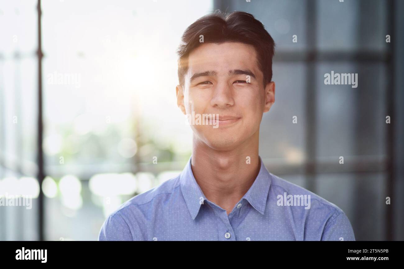 Well dressed young Asian businessman smiling confidently Stock Photo