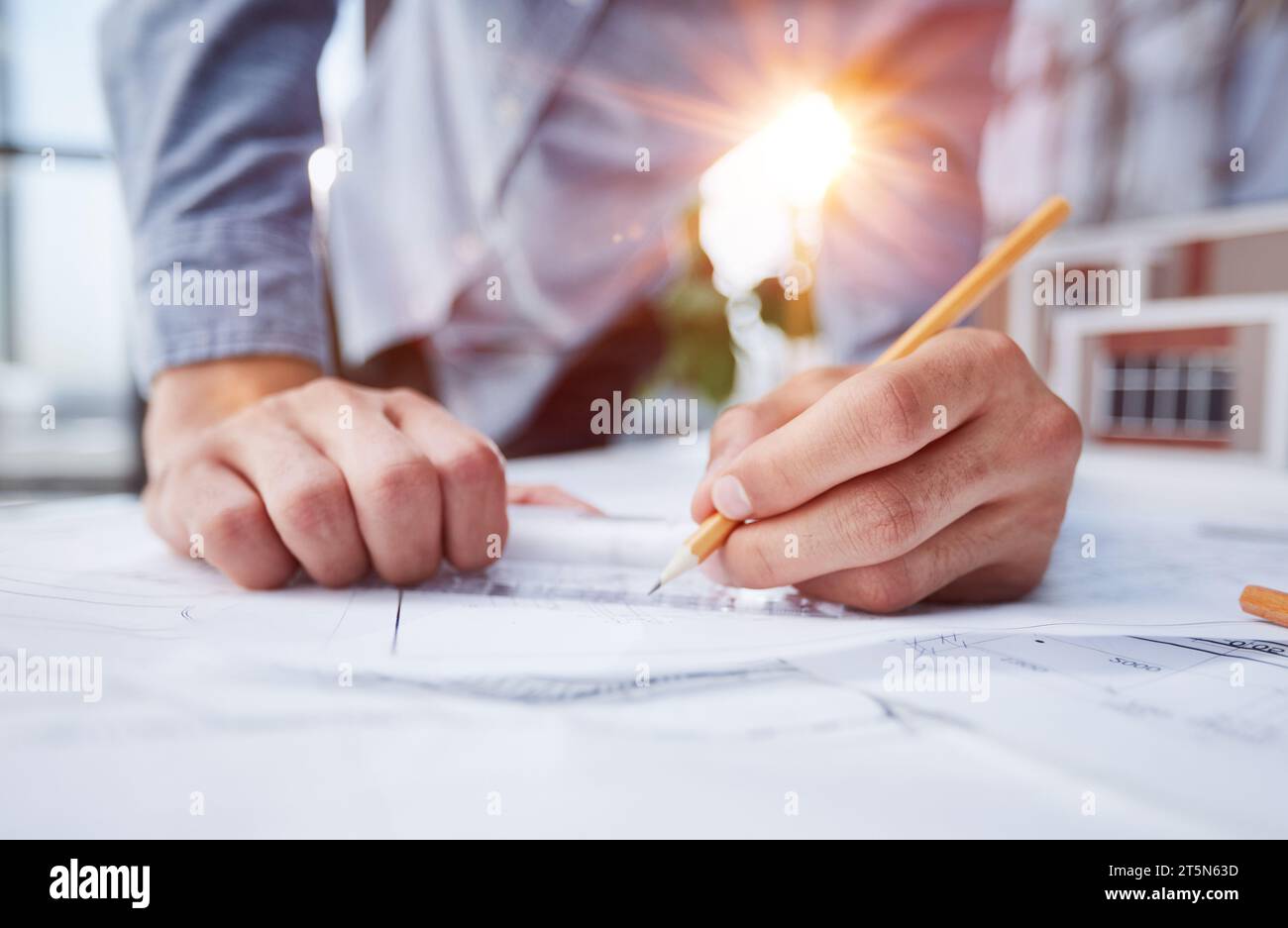 Engineer designs works according to drawings Stock Photo - Alamy