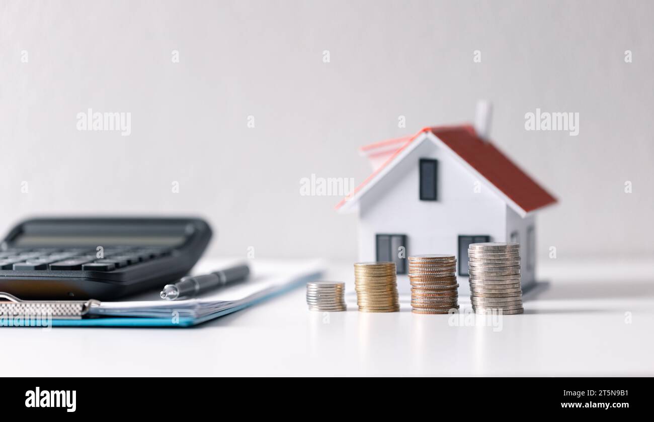 House with money. Concept of finance or refinance real estate. Symbol of house stands against background of us dollars. Property investment. Home mort Stock Photo