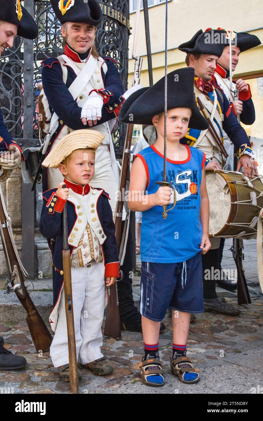 Young boys and reenactors in historic uniforms, city street, Reenactment of the Siege of Neisse during Napoleon War with Prussia in 1807, Nysa, Poland Stock Photo