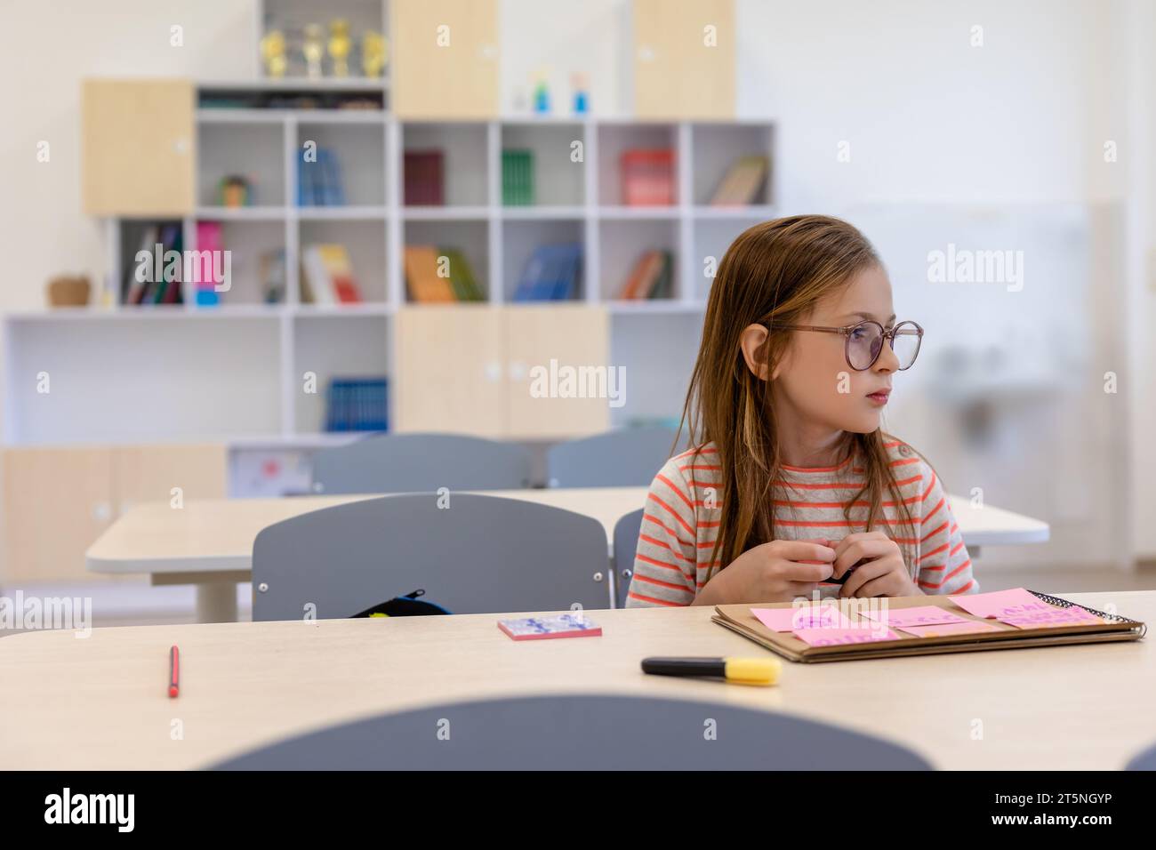 The girl sitting at the desk at the classroom at school Stock Photo - Alamy