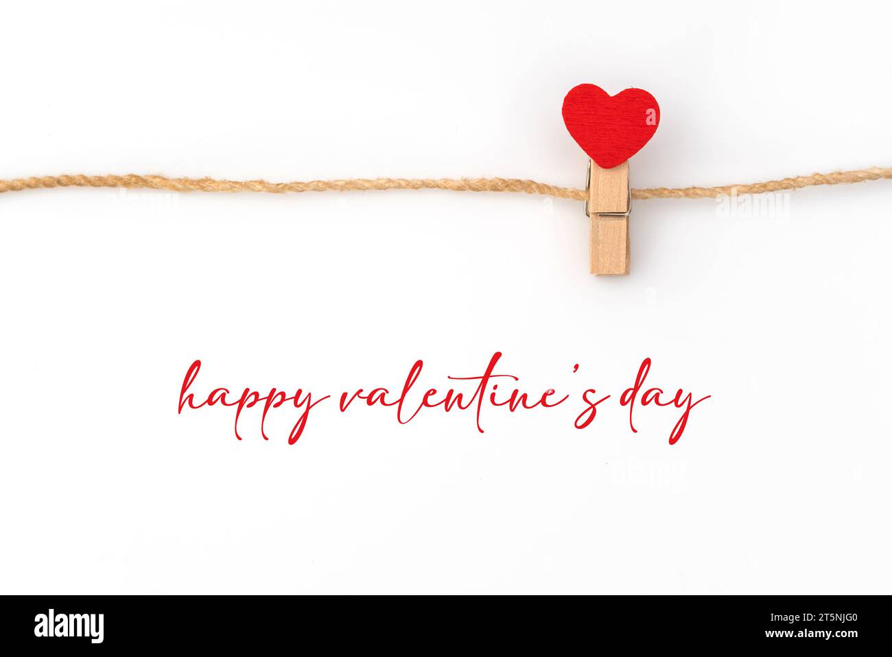 Red paper heart hanging on white background Stock Photo - Alamy