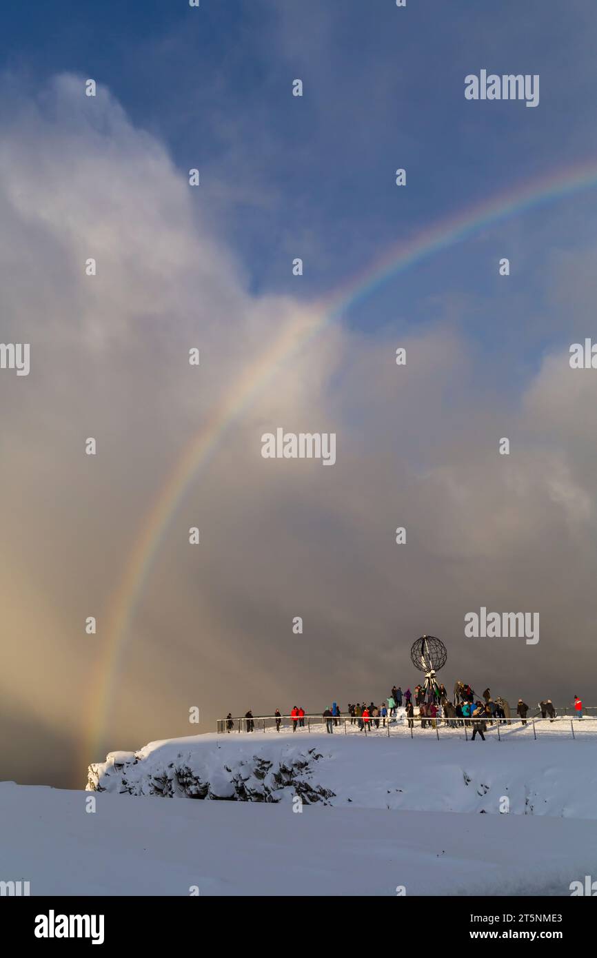Stunning rainbow with a mixture of snow and sunshine at the Globe monument structure, North Cape, Nordkapp, Norway, Scandinavia, Europe in October Stock Photo