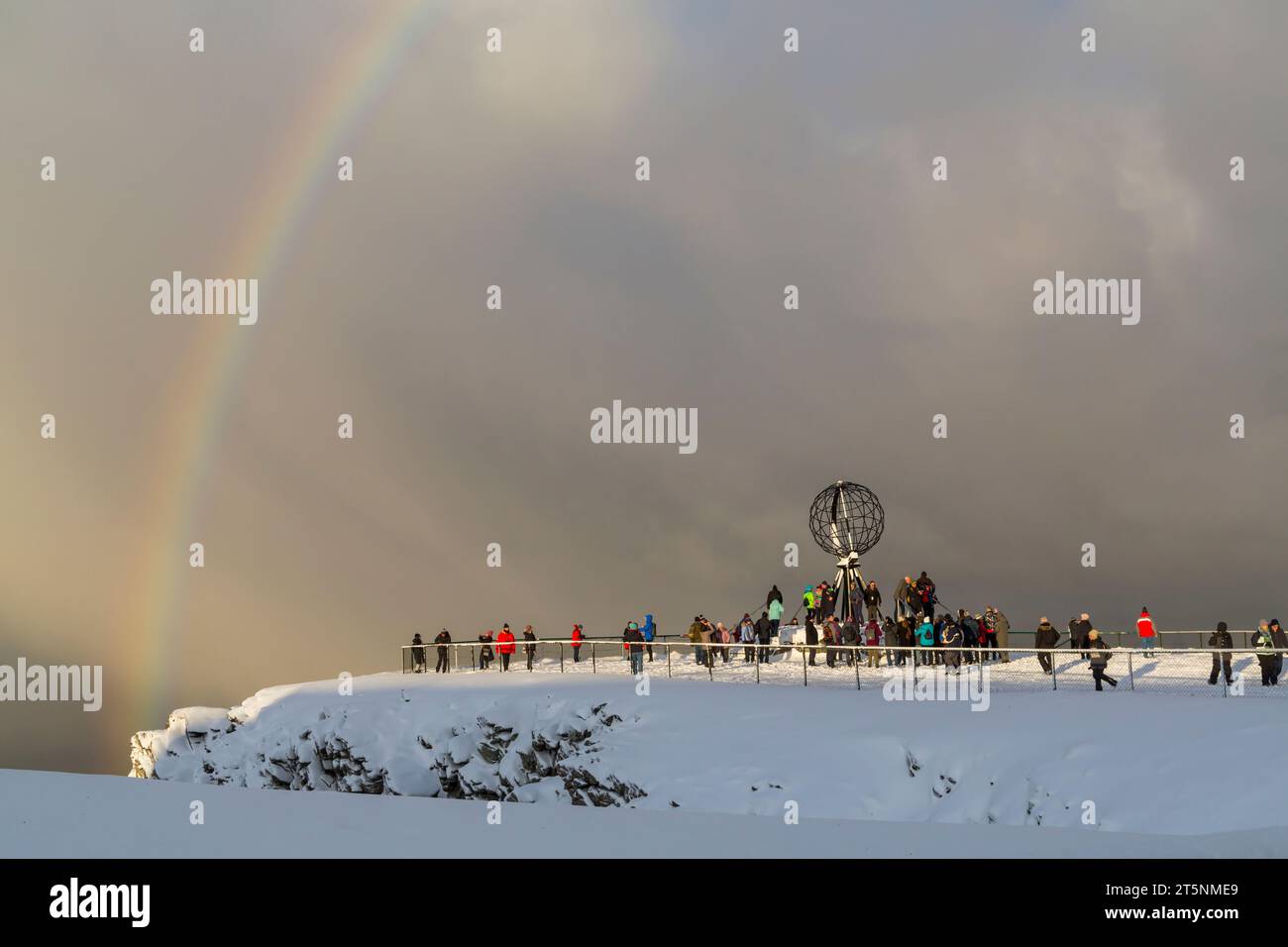 Stunning rainbow with a mixture of snow and sunshine at the Globe monument structure, North Cape, Nordkapp, Norway, Scandinavia, Europe in October Stock Photo