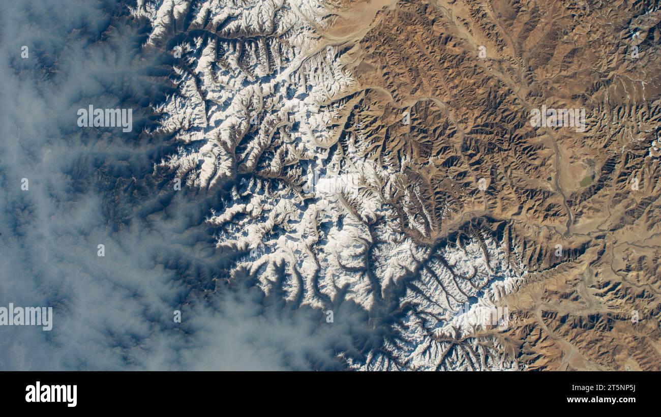 NEPAL / TIBET - 13 April 2023 - Clouds gather on Nepal's sub-tropical side of the Himalayas with Mount Everest at the center of this photograph taken Stock Photo