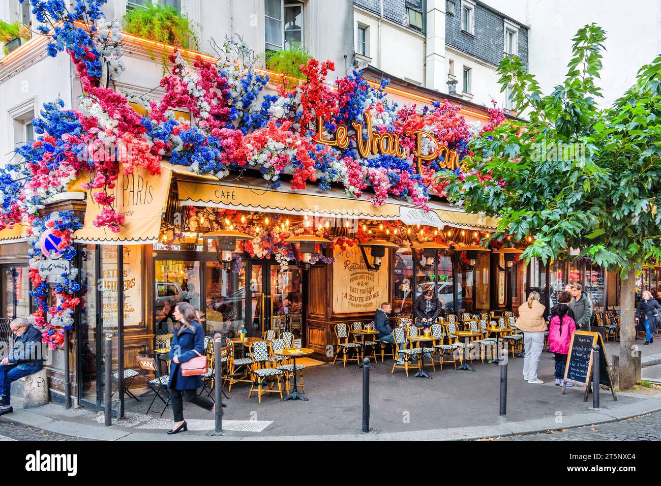 Decorated floral front of 'Le Vrai Paris' bistro on the Rue des Abbesses, Montmartre, Paris 18, France. Stock Photo