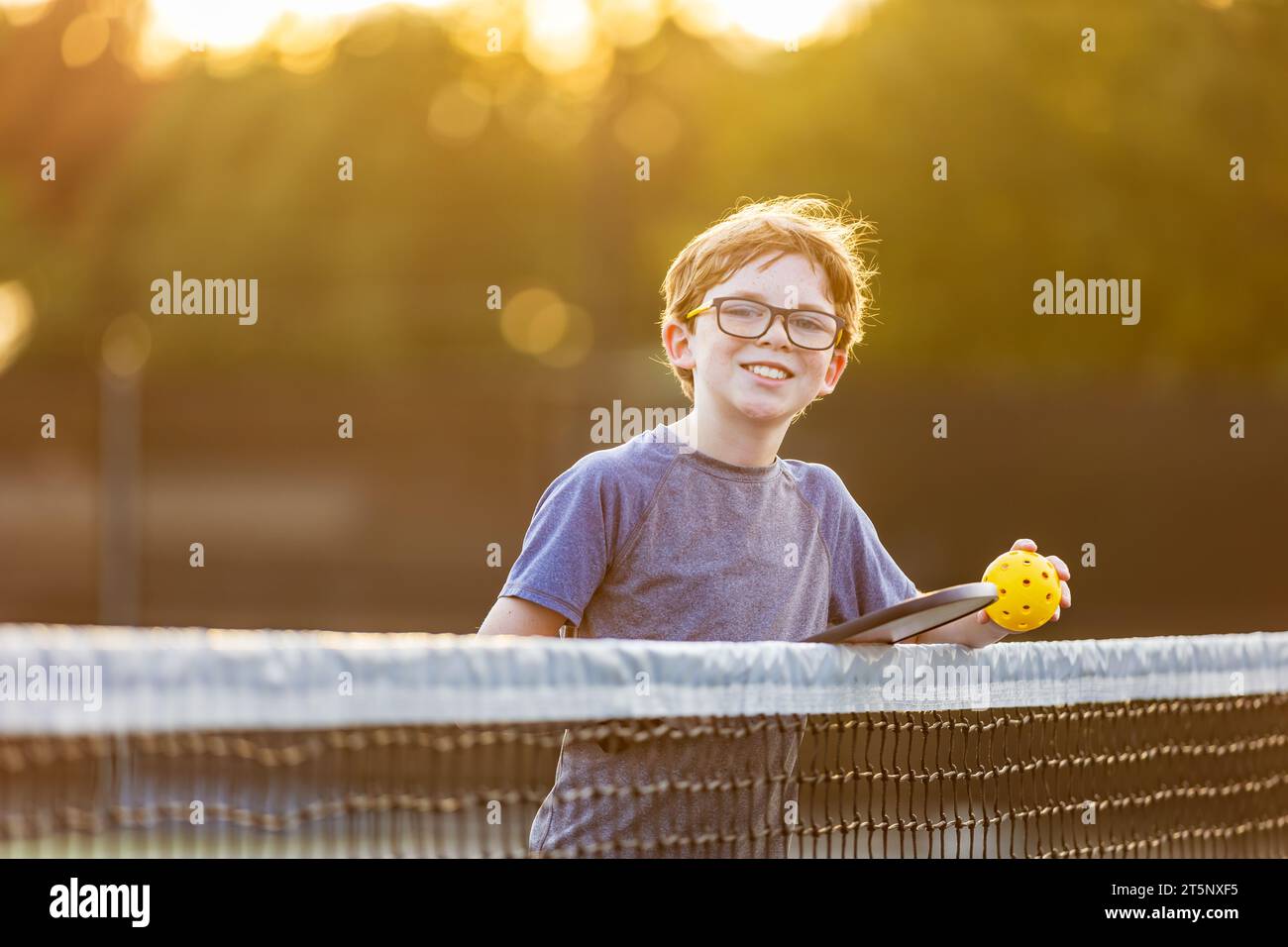 Young boy with pickleball gear on court Stock Photo Alamy