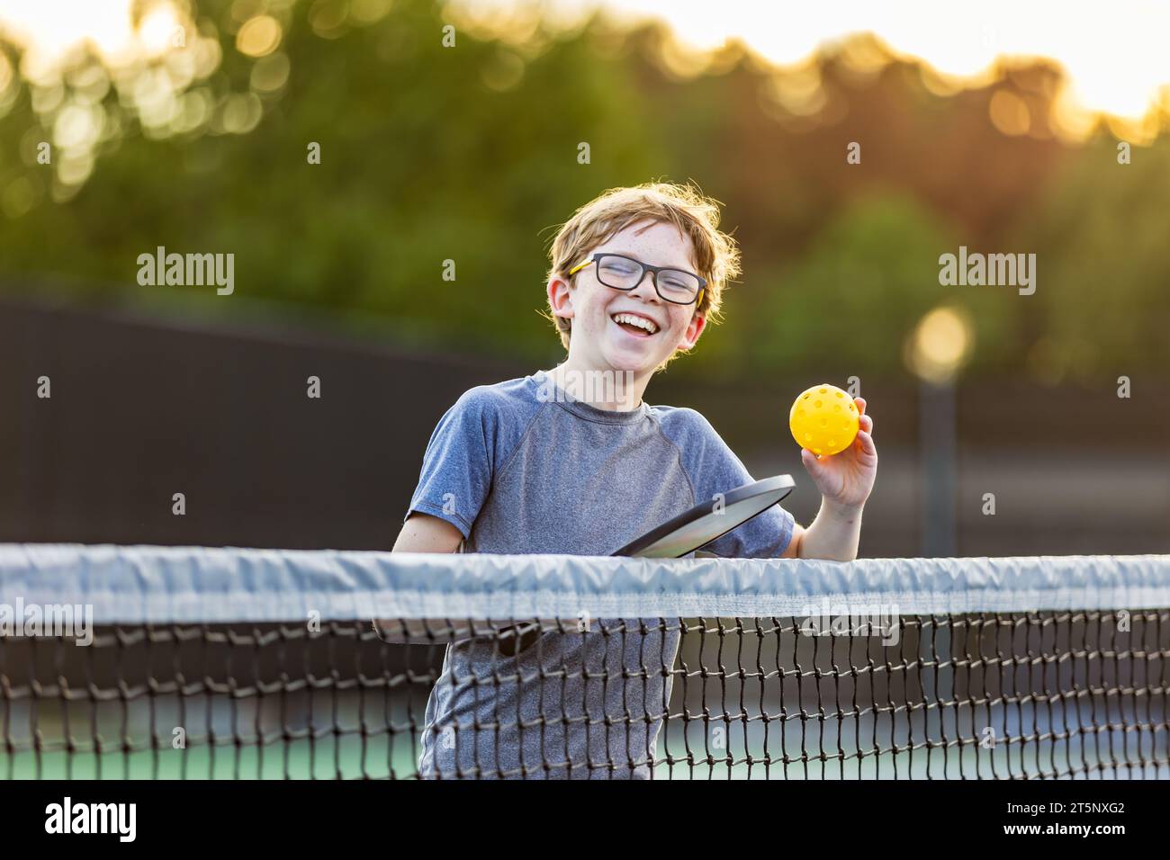Young boy with pickleball gear on court Stock Photo Alamy