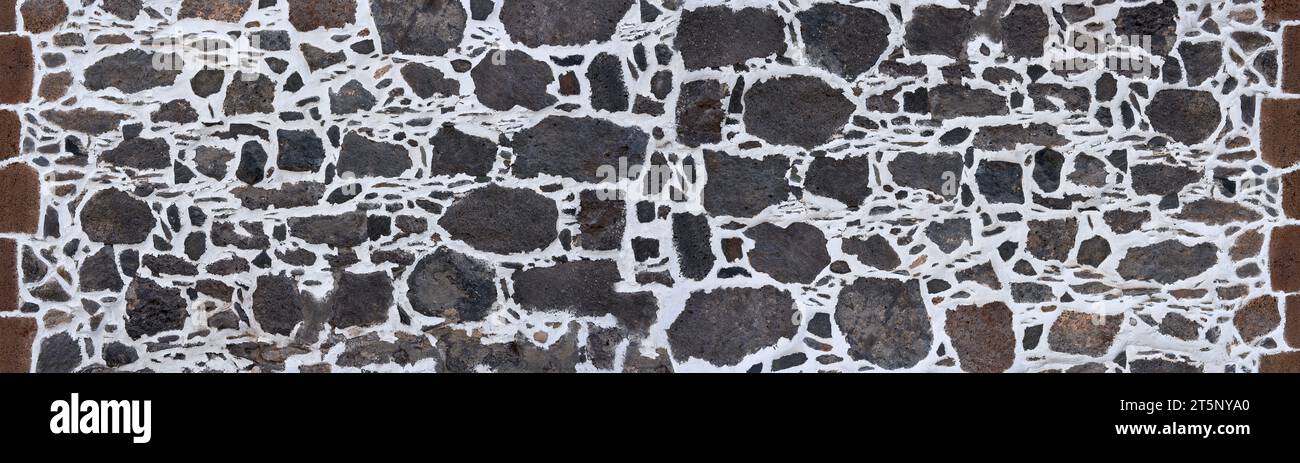Canary Islands wall made of gray volcanic rock in white plaster Stock Photo