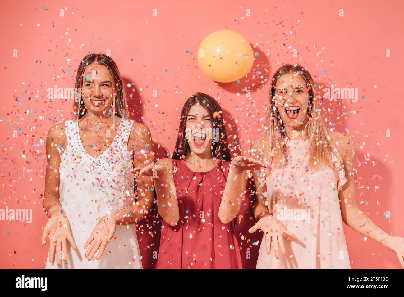Party friends posing with confetti Stock Photo Alamy
