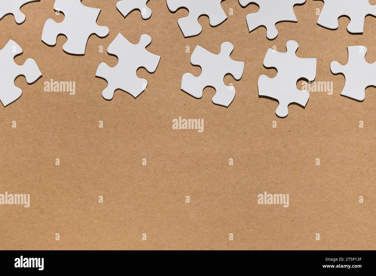 Overhead view white puzzle pieces brown paper textured Stock Photo Alamy