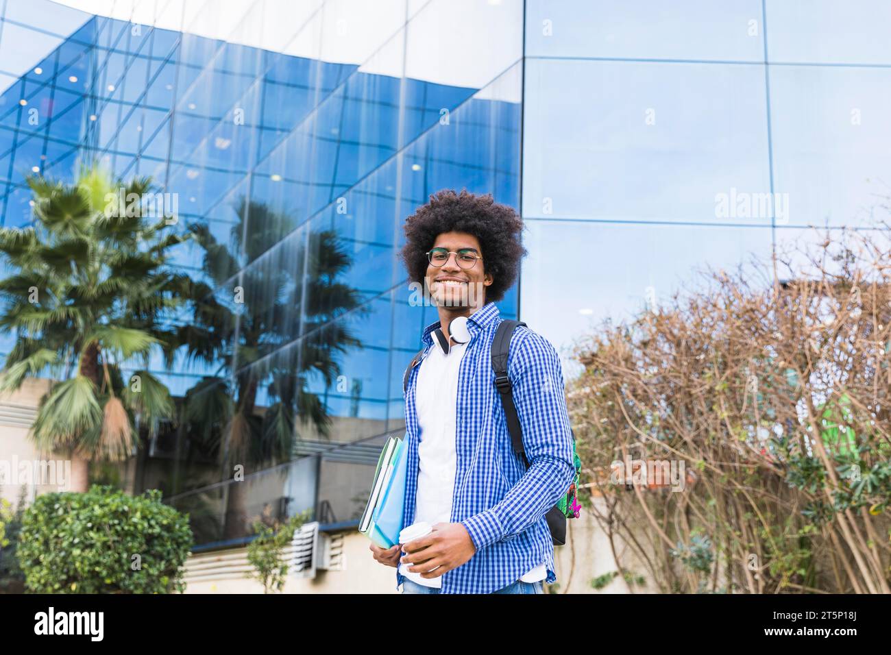 Portrait male young student standing front university building Stock Photo