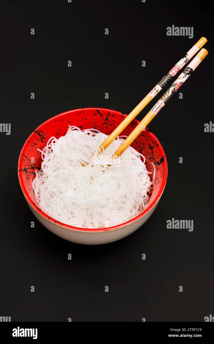 Rice vermicelli bowl with chopstick black surface Stock Photo Alamy