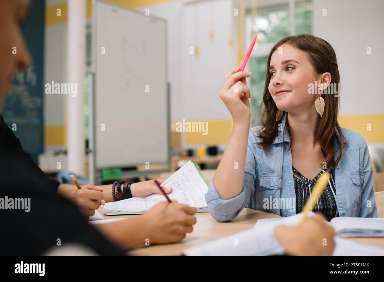 Teen girl pointing up Stock Photo