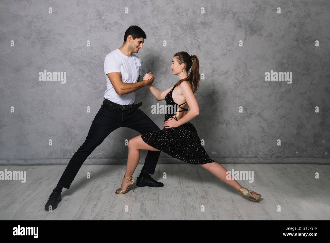 Young dance partners dancing tango Stock Photo