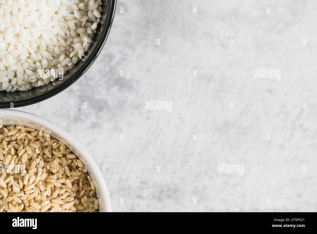 Bowls with brown white rice table Stock Photo