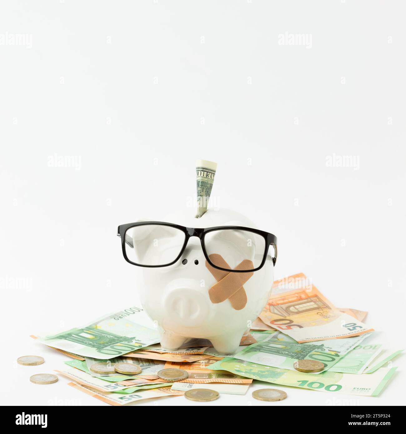 Broken piggy bank wearing glasses Stock Photo - Alamy