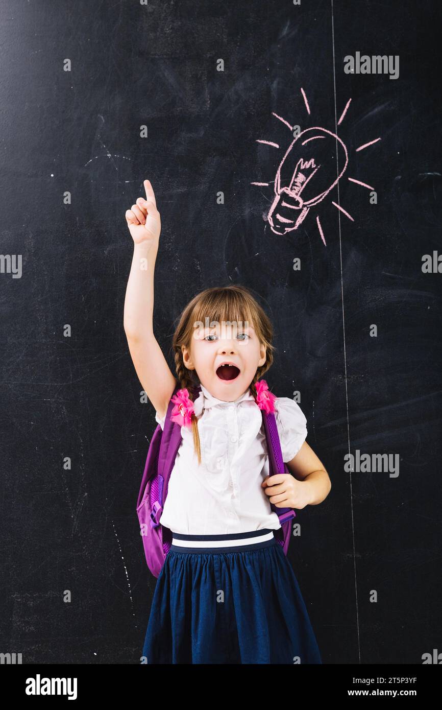Excited girl pointing up Stock Photo