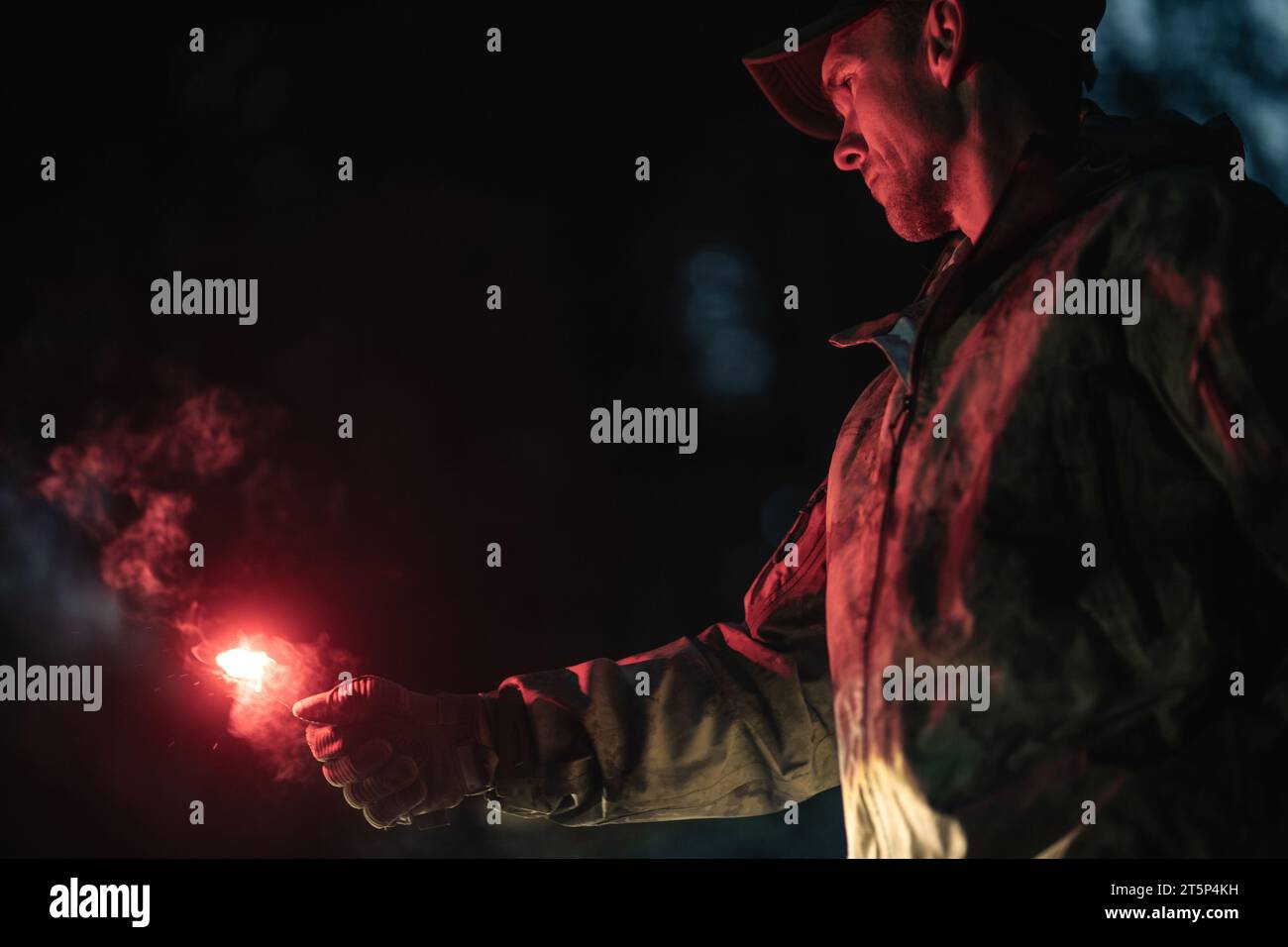Caucasian Man with Burning Emergency Flare in His Hand During Night Hours Stock Photo