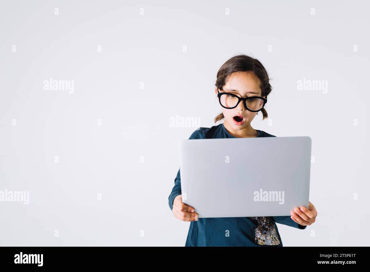 Shocked girl looking laptop Stock Photo