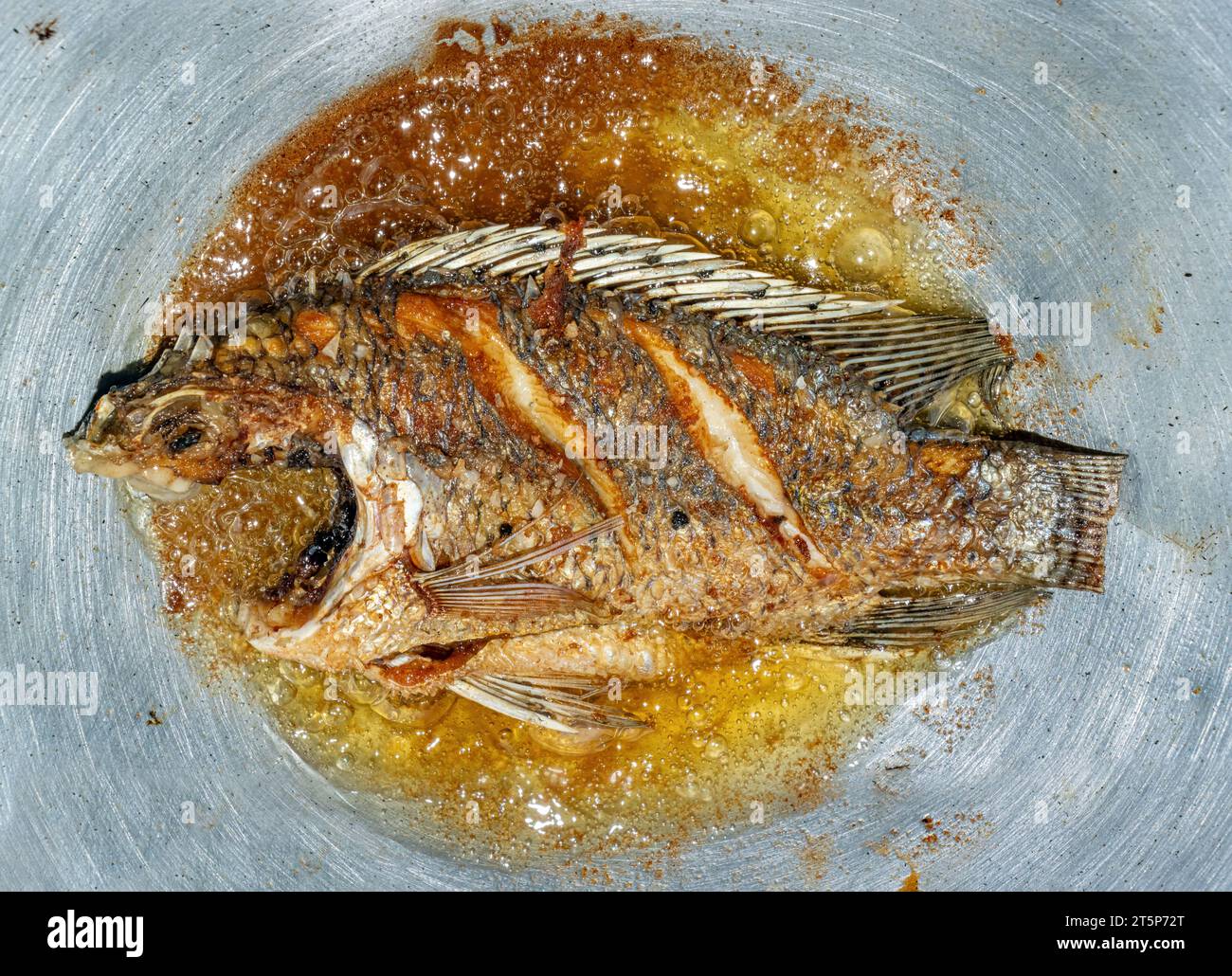 Tilapia fish is fried in oil in a pan, top view Stock Photo Alamy