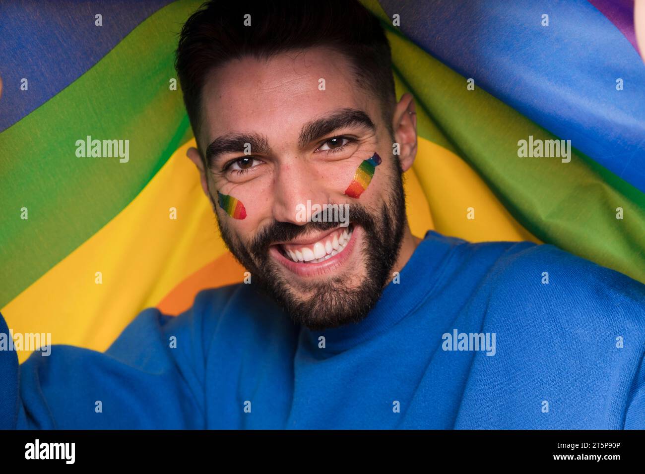 Man with lgbt rainbow face gay parade Stock Photo