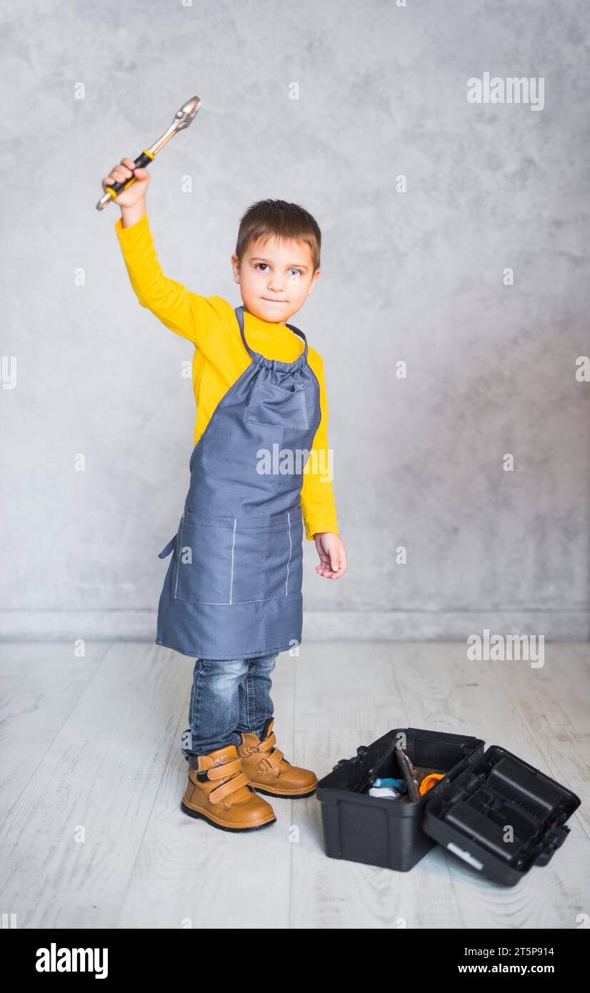 Little boy standing with spanner Stock Photo