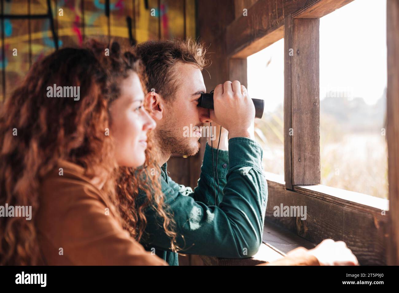 Sideways couple inside shelter Stock Photo