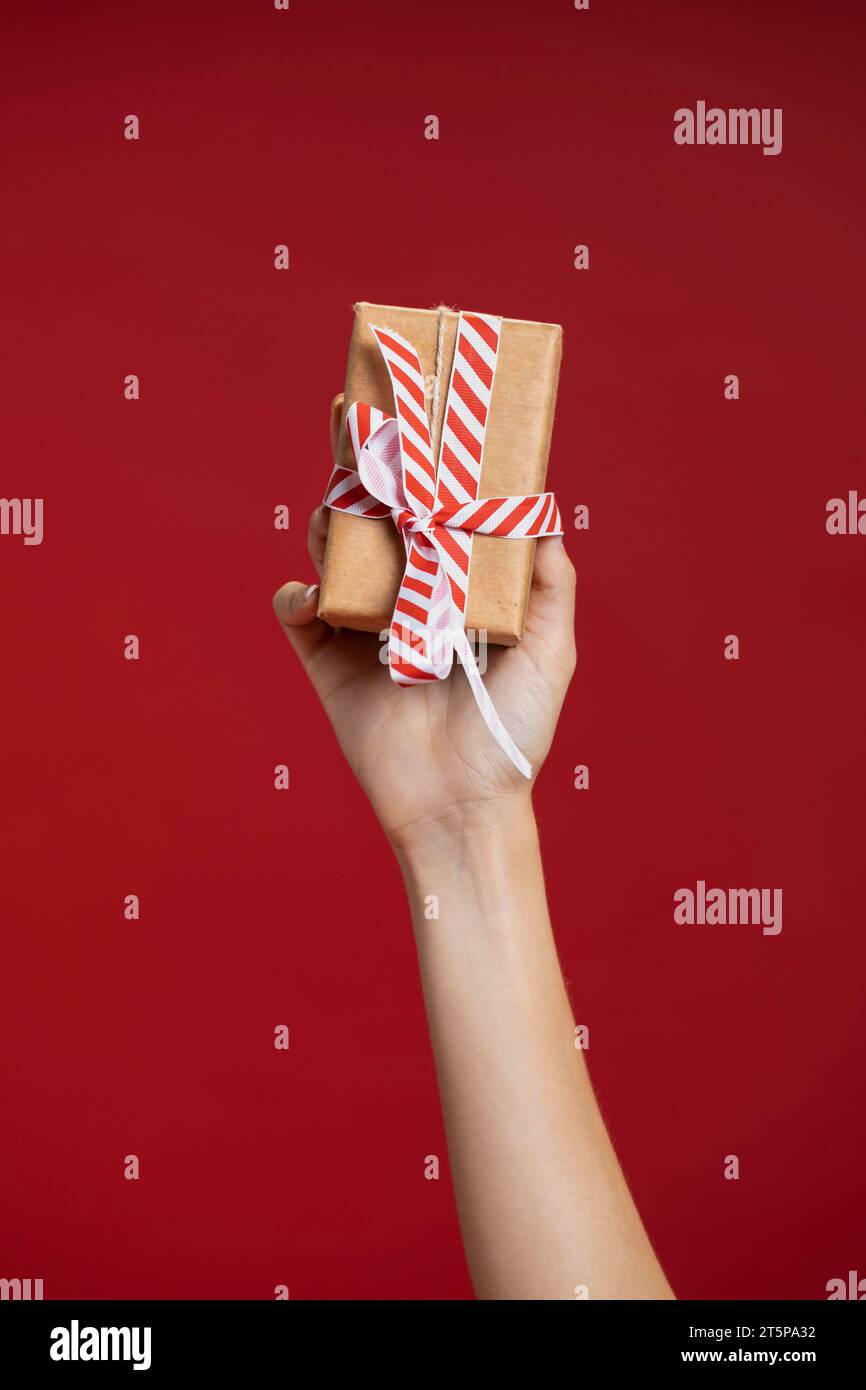 Woman holding up wrapped gift Stock Photo