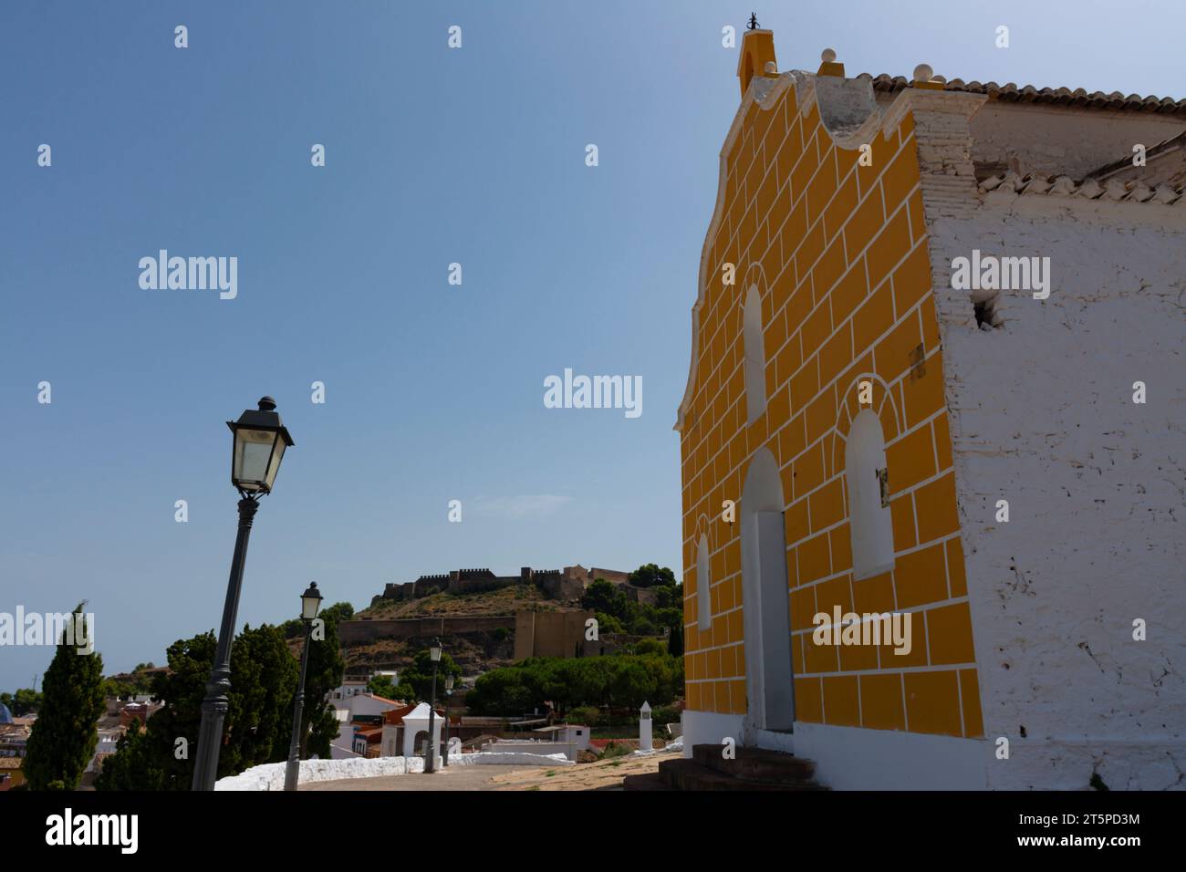 Sagunto, Valencia, Spain. August 30th, 2022 - Hermitage on the hill above the city. In the background, on the mountain, the fortified walls of the Rom Stock Photo