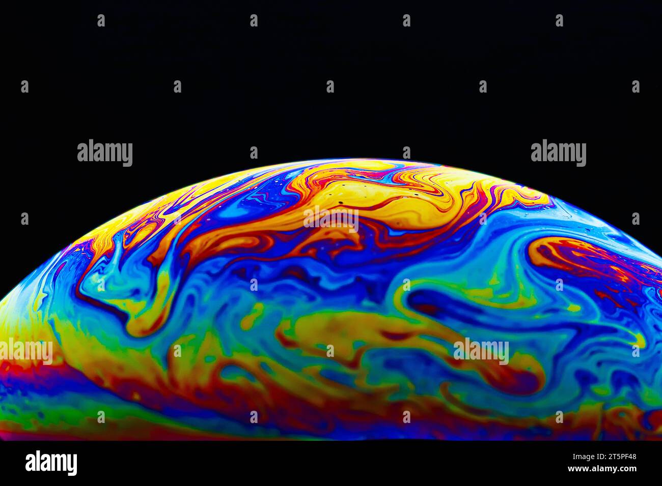 Colorful soap bubble on black background. Stock Photo