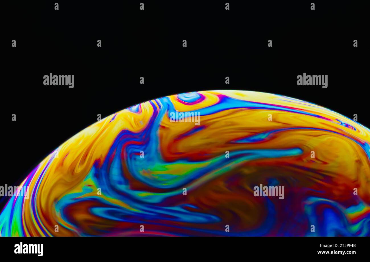 Colorful soap bubble on black background. Stock Photo