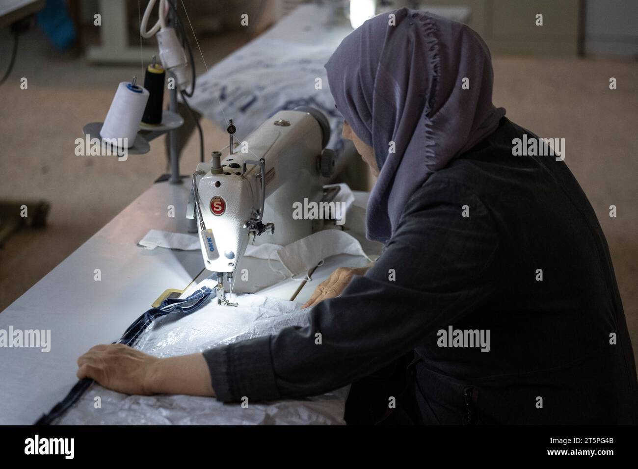 Saatari, Jordan. 06th Nov, 2023. A woman sits at a sewing machine in a sewing in the