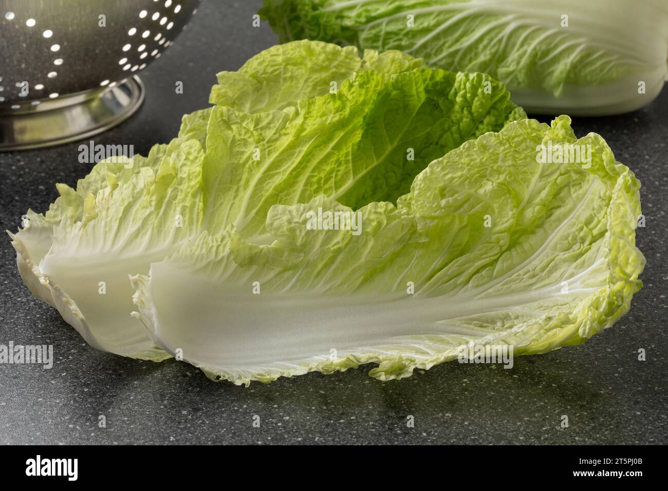 Pair of fresh raw Chinese cabbage leaves close up on a cutting board Stock Photo