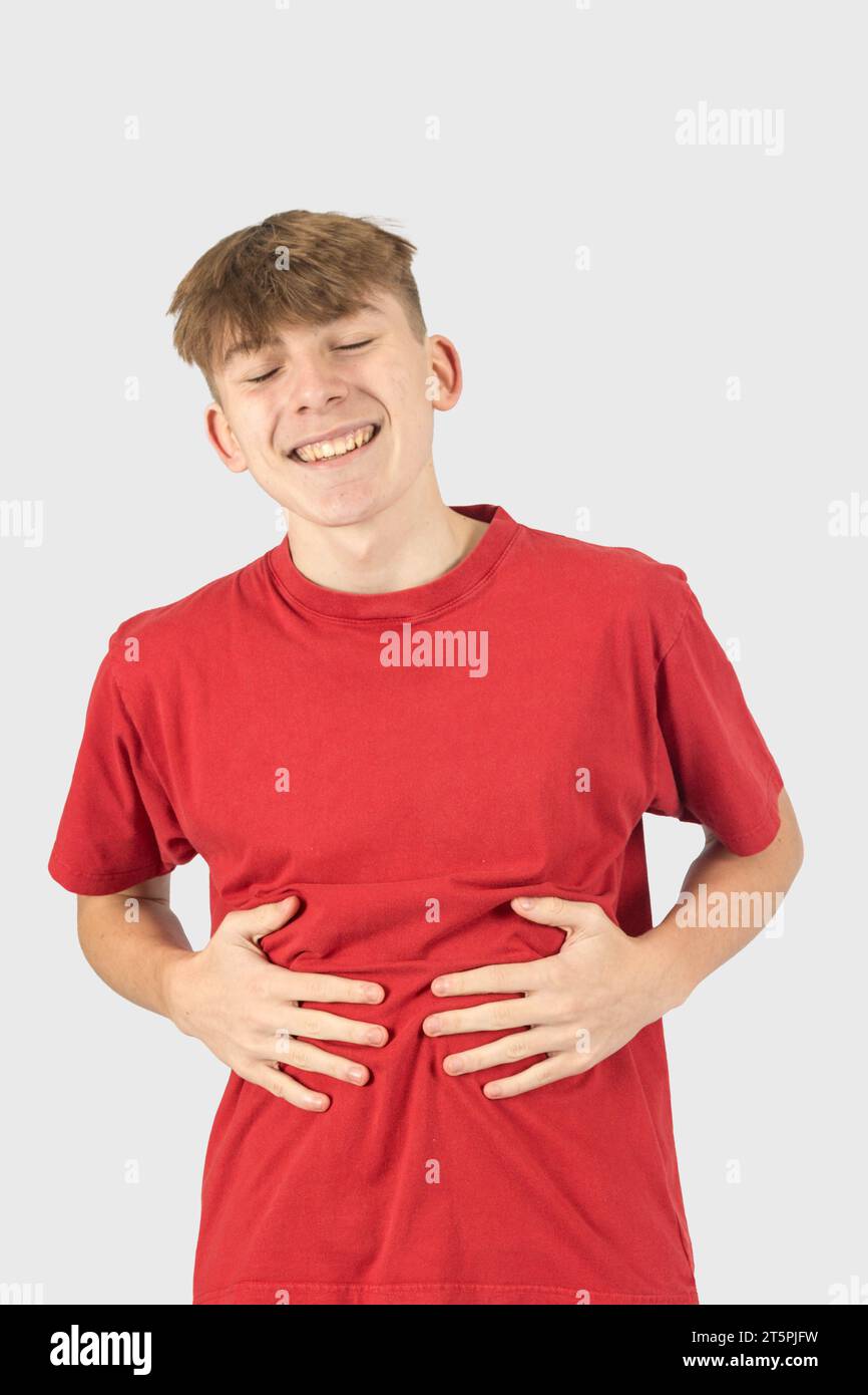 A Studio Portrait Of A Pleased Fifteen Year Old Teenage Boy Rubbing His a-studio-portrait-of-a-pleased-fifteen-year-old-teenage-boy-rubbing-his