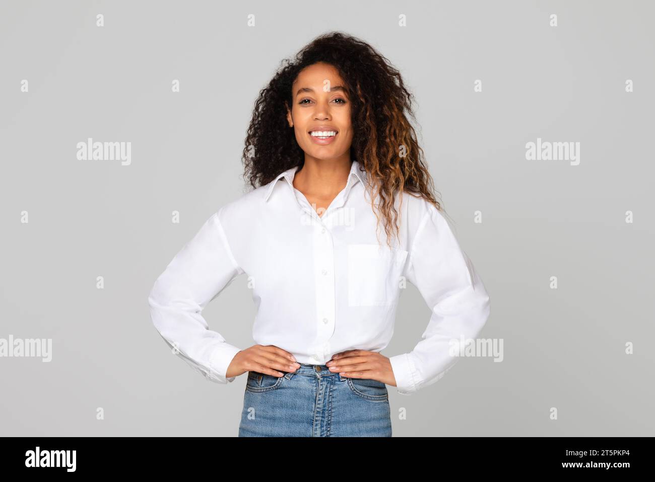 african lady holding hands on hips standing with confidence, studio Stock Photo